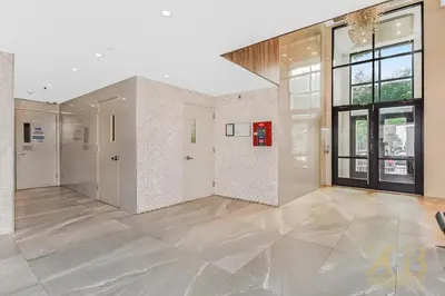 a large room with white walls and a large window at Stylish 2-Bedroom Near Central Park - Laundry - Elevator in New York