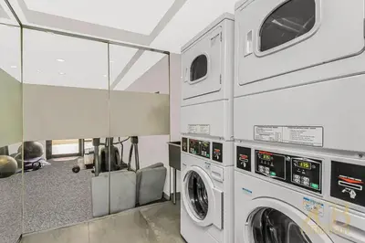 a laundry room with a washer and dryer at Stylish 2-Bedroom Near Central Park - Laundry - Elevator in New York