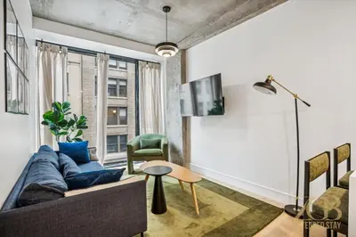 a living room with a couch and a table at Modern 2BR with WD in Elevator Building in NoMad in New York
