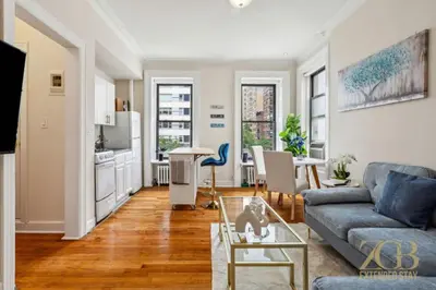 a living room with a couch and a table at Sweet and Cozy 1 Bedroom Apt in Lenox Hill in New York