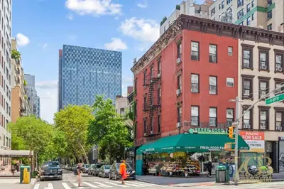 a city street with a store in front of a building at Sweet and Cozy 1 Bedroom Apt in Lenox Hill in New York