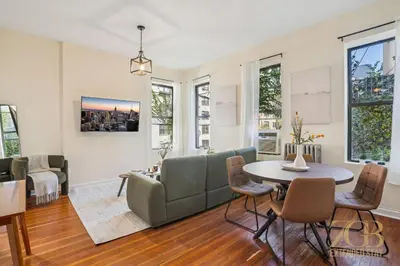 a living room with a couch and a table at Stylish 2-Bedroom Apartment in the Upper East Side in New York