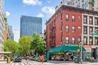 a city street with a store in front of a building at Stylish 2-Bedroom Apartment in the Upper East Side in New York