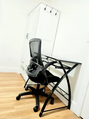 a black chair sitting in front of a desk at Cozy 2BR in Newark for Families, Work & Long Stays in Newark