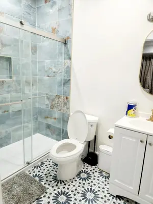 a bathroom with a toilet and a shower at Cozy 2BR in Newark for Families, Work & Long Stays in Newark