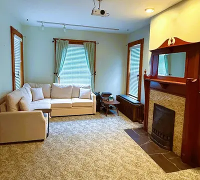 a living room with a couch and a fireplace at The Pink Haus