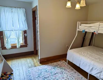 a bedroom with a bunk bed and a window at The Pink Haus
