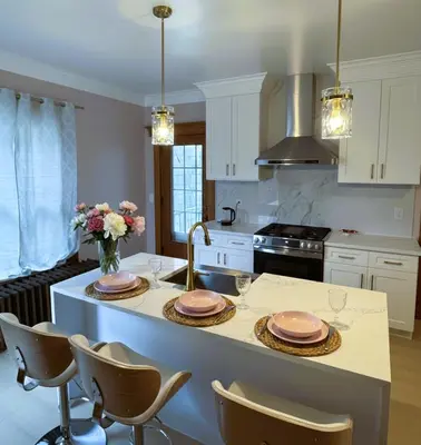 a kitchen with a island with two plates on it at The Pink Haus