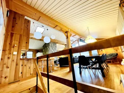 a dining room and living room in a log house at Villa Adriana 4bdr 2 bath lake front dream home in Vernon