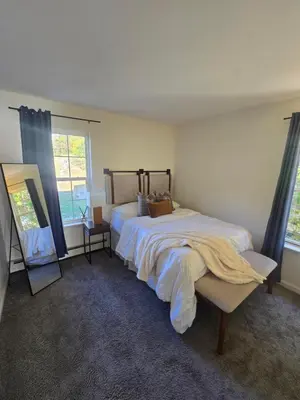 a bedroom with a large bed and a mirror at Cozy Private Suite Near Train to NYC in Fairfield