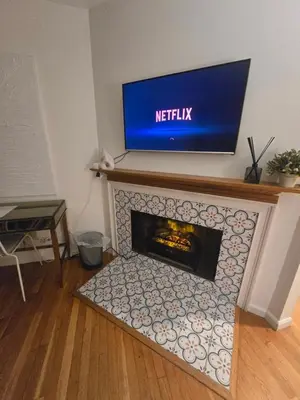 a fireplace with a tv on top of it at Cozy Private Suite Near Train to NYC in Fairfield
