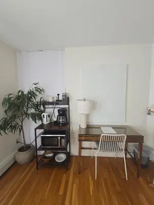 a room with a desk and a table with a coffee maker at Cozy Private Suite Near Train to NYC in Fairfield