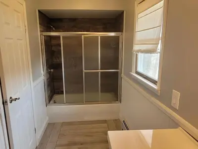 a bathroom with a shower with a glass door at Cozy 4 Bedrooms Pool Game Room in Tobyhanna