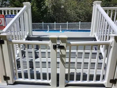 a white railing on a porch with a pool at Cozy 4 Bedrooms Pool Game Room in Tobyhanna