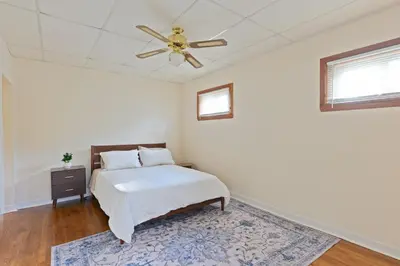 a bedroom with a bed and a ceiling fan at All-American classic,18 min to Manhattan in Carlstadt