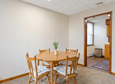 a dining room with a wooden table and chairs at Classic American-style, 18 min to NYC in Carlstadt