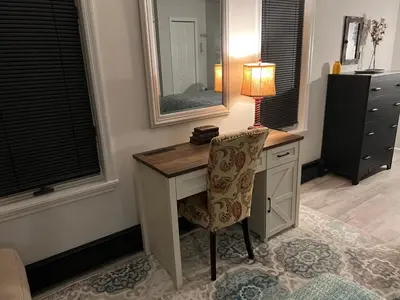 a desk with a lamp and a chair in a room at Cozy Studio Apartment in Montgomery