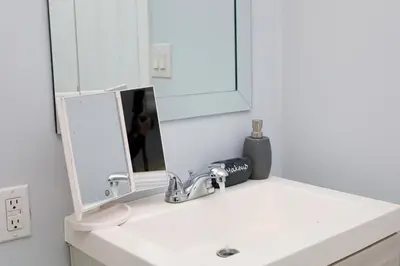 a bathroom with a sink and a mirror at Modern Lakeview Escape | Scenic Deck • Fire Pit in Monroe