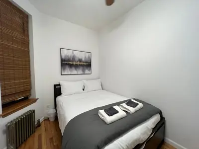a bedroom with a bed with two towels on it at Signature by Times Square in New York