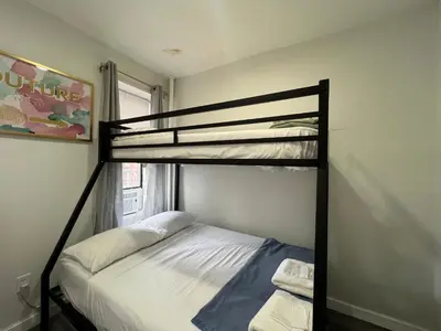 a bedroom with two bunk beds and a window at Signature by Times Square in New York