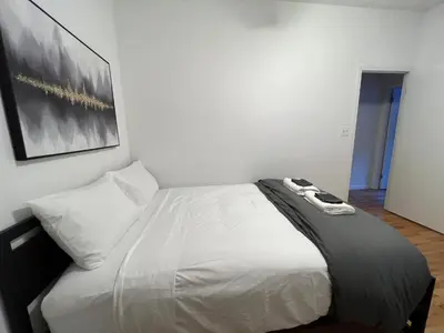 a bedroom with a bed with a black and white blanket at Signature by Times Square in New York