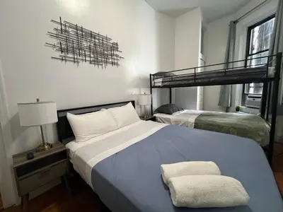 a bedroom with two beds and a bunk bed at Parkline Suites Upper West Side in New York