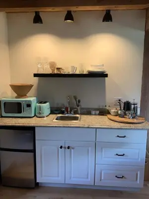 a kitchen counter with a microwave and a sink at The Colrain Suite in Colrain