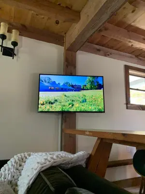 a flat screen tv on a wall in a room at The Colrain Suite in Colrain