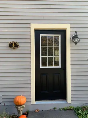a black door on a house with a pumpkin at The Colrain Suite in Colrain