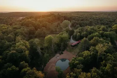 an aerial view of a farm with a barn and a lake at Mural Art Cabin With Pond And Hot Tub in Narrowsburg