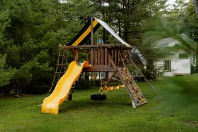 a playground with a slide in a yard at Waterfront 1900s Hot Tub Eldred Homestead in Eldred