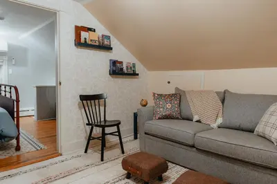 a living room with a couch and a chair at Creekfront Cabin Sauna & Hot Tub Hikers Hollow in Cuddebackville