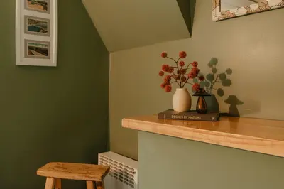 a room with a counter with a vase with flowers on it at Creekfront Cabin Sauna & Hot Tub Hikers Hollow in Cuddebackville