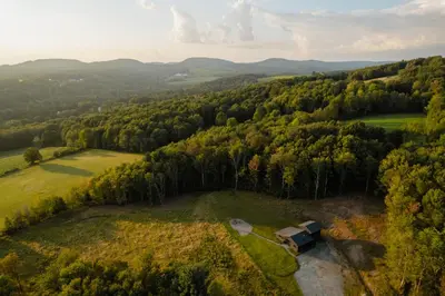 an aerial view of a farm with a barn in a field at Onyx Ridge Breathtaking Views 14 Acres in Jeffersonville
