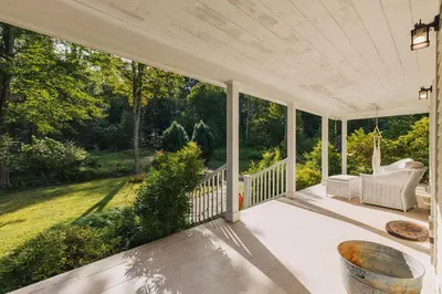 a screened porch with a view of a yard at Secluded Charming Farmhouse Lake Views Firepit in Narrowsburg