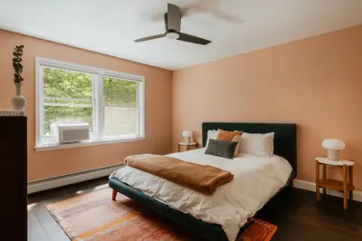 a bedroom with a bed and a window at Woods Edge Private 5 Acres Hot Tub Fire Pit in Barryville