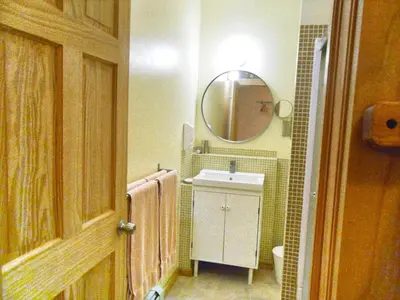 a bathroom with a sink and a mirror at Catskill Rose Lodging & Dining in Mount Tremper