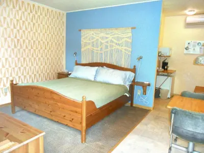 a bedroom with a wooden bed in a room at Catskill Rose Lodging & Dining in Mount Tremper