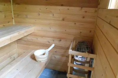 a wooden sauna with a toilet and a ladder at Catskill Rose Lodging & Dining in Mount Tremper