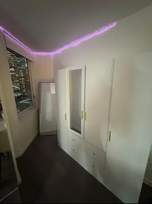 a room with white walls and purple lights on the ceiling at LOFT IN WITH ALL AMENETIES BUILDING BEST LOCATION IN MIDTOWn in New York