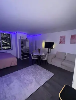 a living room with a couch and a table at LOFT IN WITH ALL AMENETIES BUILDING BEST LOCATION IN MIDTOWn in New York