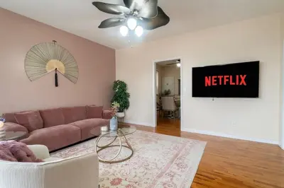 a living room with a couch and a netflix sign at The Boulevard Stay! 25 mins to NYC! Spacious 2BR! in Harrison