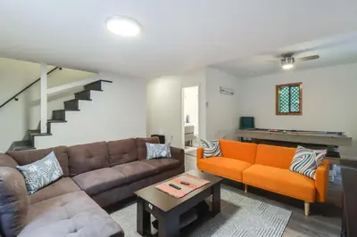 a living room with a couch and a table at 1 Mi to Lake, Golf and Ski Access The Hideout Home! in Arlington