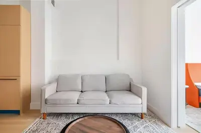a white couch in a living room with a rug at 19-4I Stylish 1BR in the Heart of the East Village in New York
