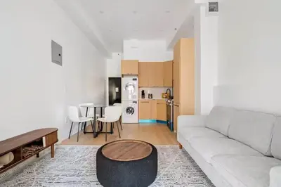 a living room with a couch and a table at 19-4I Stylish 1BR in the Heart of the East Village in New York