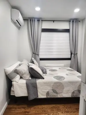 a bed in a room with a window with curtains at Modern & Tranquil Apartment in Bogota