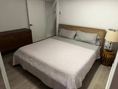 a bedroom with a large bed with a white bedspread at Modern Townhouse in Historic Harlem in New York
