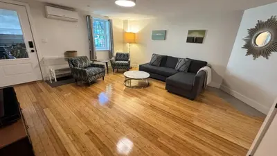 a living room with a couch and a table and chairs at Modern Townhouse in Historic Harlem in New York