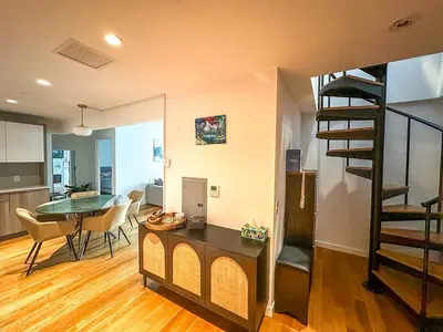 a kitchen and a living room with a spiral staircase at Penthouse in Greenpoint in Brooklyn