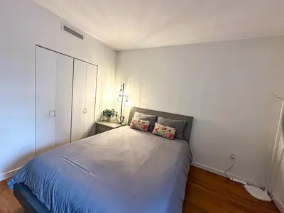 a bedroom with a bed with two pillows on it at Penthouse in Greenpoint in Brooklyn